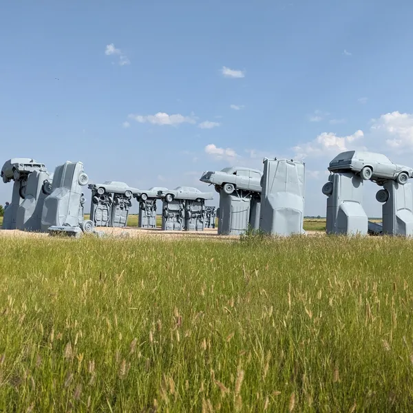 Cars rising out of the ground as stonehenge.