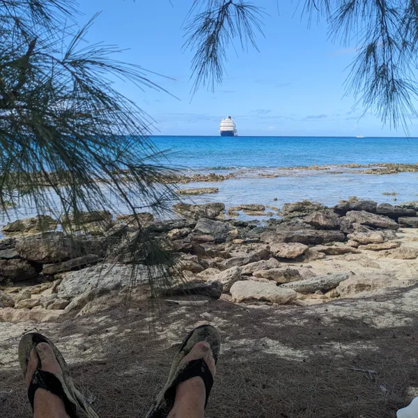 Rocky beach and boat from shade.